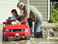 Grandpa helps wash grandson’s car