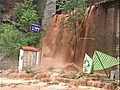 Raw: Flood water rushes through city