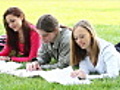 Three students studying outdoors.