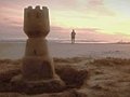 1006) Beach Jogger And Sand Castle Sunrise Stock Footage