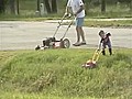 Dad Mows Lawn While Son 