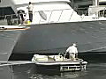 Royalty Free Stock Video SD Footage Supervisor Maneuvers a Small Boat at a Dry Dock and Boat Yard in Ft. Lauderdale,  Florida