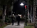 Royalty Free Stock Video SD Footage Pan Right to Holiday Lights and Walkway as People Pass by on the New River in Downtown Ft. Lauderdale,  Florida