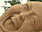 Sculptors use sand to carve out works of art