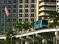 Royalty Free Stock Video HD Footage High Rise Condos,  Office Buildings as People Mover Car Departs in Downtown Miami, Florida