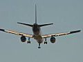 Royalty Free Stock Video HD Footage Commercial Jet on Final Approach Passes Over a Warehouse Building at Sunset at Ft. Lauderdale Airport in Florida