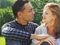 Couple sits in park and talk,  woman with braces