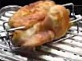 Grilling a chicken on a barbecook Banika