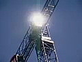 Royalty Free Stock Video SD Footage Quick Zoom Out From Bright Sun on Operators Cab to Tower Crane Operating at a Construction Project in Ft. Lauderdale,  Florida