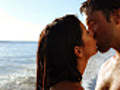 Attractive couple kiss in the water