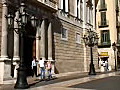 Royalty Free Stock Video HD Footage Pan Down to Police Officer and  Building in a Plaza in Barcelona,  Spain