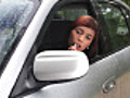 Woman do makeup on car mirror