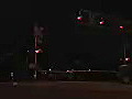 Royalty Free Stock Video HD Footage Night View of a Railroad Crossing as a Train Passes By