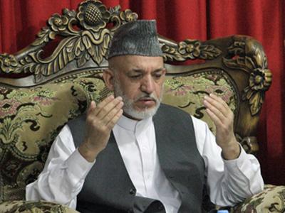 Afghan president buries slain half brother