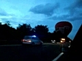 Two hot air balloons land on motorway