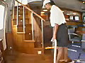 Royalty Free Stock Video SD Footage Cabin Attendant Vacuums the Interior on a Yacht in Ft. Lauderdale,  Florida