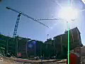 Royalty Free Stock Video SD Footage Bright Sun and Tower Cranes Operating at a Construction Project in Ft. Lauderdale,  Florida With a Fish Eye Lens