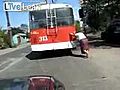 Old Woman Pushes A Broken Trolley Bus