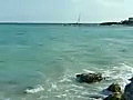 Royalty Free Stock Video SD Footage Zoom Out to Scenic View of Point and Lighthouse on Cancun Beach in Mexico