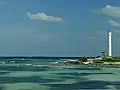 Royalty Free Stock Video SD Footage Zoom Out to Scenic View of Point and Lighthouse on Cancun Beach in Mexico