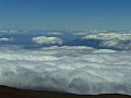 Royalty Free Stock Video SD Footage Zoom Out From Cloud Covered Mountains to Edge of Haleakala Crater in Maui,  Hawaii