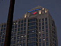 Royalty Free Stock Video HD Footage Pan Up to Glass Windows and Office Building at Sunset in Downtown Ft. Lauderdale,  Florida