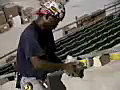 Royalty Free Stock Video SD Footage Steel Workers Pours Epoxy WHile Installing a Steel Handrail at a Construction Site for a New Arena in Miami,  Florida