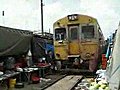 Train drives through Bangkok market