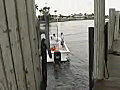 Royalty Free Stock Video SD Footage Small Boat Leaves a Dock on the Intracoastal Waterway in Ft. Lauderdale,  Florida