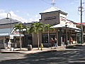 Royalty Free Stock Video SD Footage Zoom Out From Mountains to Traffic on City Street in Lahaina in Maui Hawaii as People Pass By