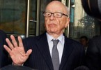 Murdoch meets victim’s family as 2 execs resign