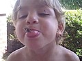 Boy Holds A Cicada In Mouth