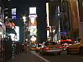 Royalty Free Stock Video SD Footage Brightly Lit Signs as People and Traffic Pass by in the Bright Lights of Times Square on a Hot August Night in New York City