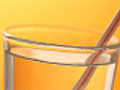 Pouring water in glass orange background