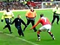 David Beckham apprehends a pitch invader at Gary Neville’s Old Trafford testimonial