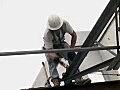 Royalty Free Stock Video SD Footage Steel Worker Adjusts a Steel Roof Joist at a Construction Site in Ft. Lauderdale,  Florida