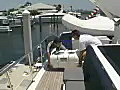 Royalty Free Stock Video SD Footage Crew Members Carry a Life Raft Container on a Large Yacht Docked on the Intracoastal Waterway in Ft. Lauderdale,  Florida