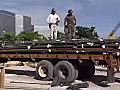 Royalty Free Stock Video SD Footage Steel Workers Standing on Top Of Truck