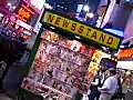 Royalty Free Stock Video SD Footage Brightly Lit Signs at a Newsstand in the Bright Lights of Times Square on a Hot August Night in New York City