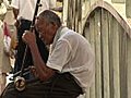 Chinese Erhu Musician Playing By Bridge Stock Footage