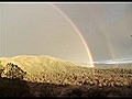 Giant Double Rainbow Over Mountains