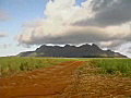 Royalty Free Stock Video SD Footage Zoom Out From Mountain Range and Fields to Dirt Road in Kauai,  Hawaii