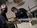 Royalty Free Stock Video SD Footage Steel Workers Check Level While Installing a Steel Handrail at a Construction Site for a New Arena in Miami,  Florida