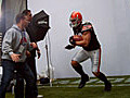 Peyton Hillis stiff arms the EA SPORTS Creative Director