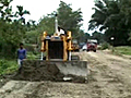In Assam,  a road being built through a reserved forest